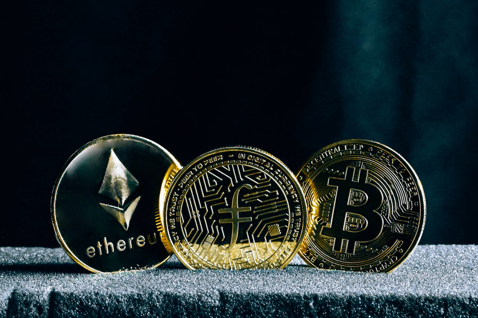 three bitcoins sitting on top of a table